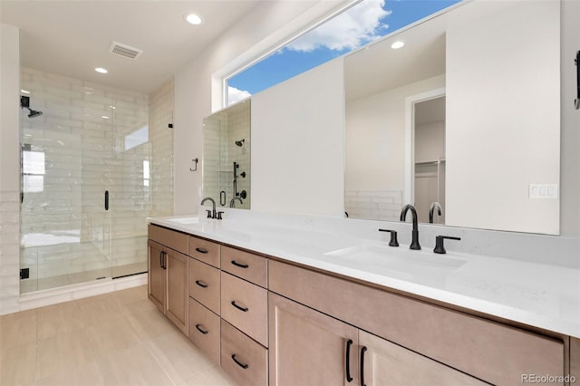 bathroom with tile patterned flooring, vanity, and an enclosed shower