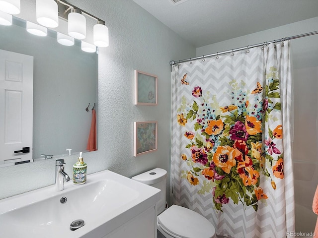 23222 E Orchard Pl, Aurora, CO 80015 - bathroom featuring a textured wall, vanity, and a shower with shower curtain