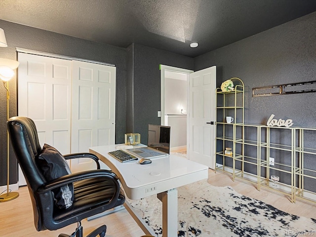 23222 E Orchard Pl, Aurora, CO 80015 - home office with a textured wall, wood finished floors, and a textured ceiling