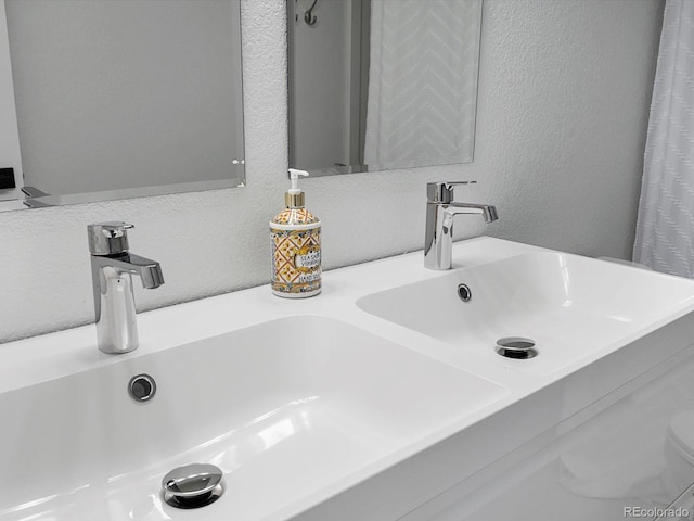 23222 E Orchard Pl, Aurora, CO 80015 - bathroom view of a textured wall and double vanity