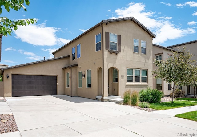 2592 S Norse Ct, Lakewood, CO 80228 - mediterranean / spanish house featuring driveway, stucco siding, and a garage