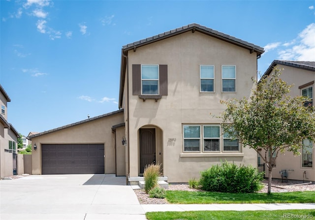 2592 S Norse Ct, Lakewood, CO 80228 - view of front of property with concrete driveway, an attached garage, and stucco siding