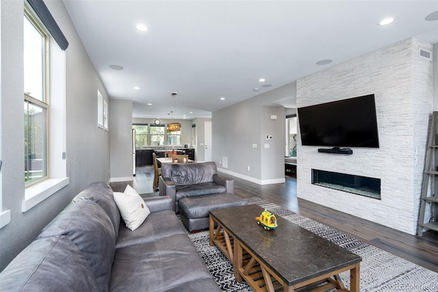 2592 S Norse Ct, Lakewood, CO 80228 - living area featuring visible vents, baseboards, a stone fireplace, dark wood-style floors, and recessed lighting