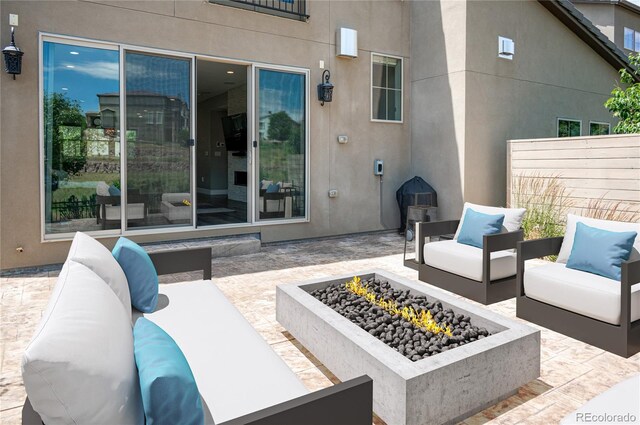 2592 S Norse Ct, Lakewood, CO 80228 - view of patio / terrace featuring an outdoor living space with a fire pit and fence