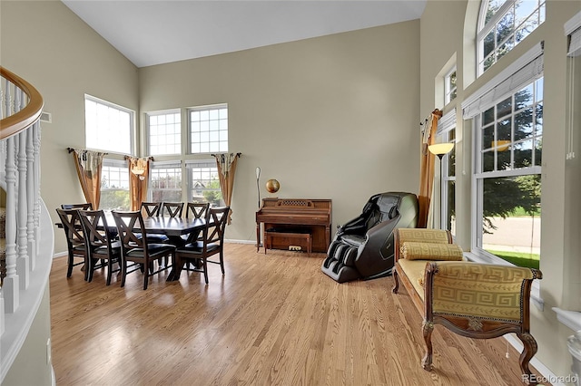 dining area with a high ceiling and light wood-type flooring