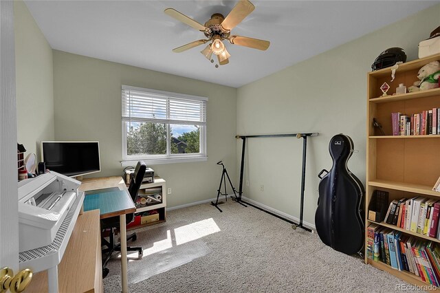 carpeted office space with ceiling fan