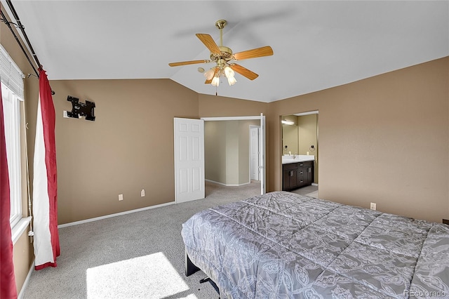 bedroom featuring ceiling fan, connected bathroom, carpet, and lofted ceiling