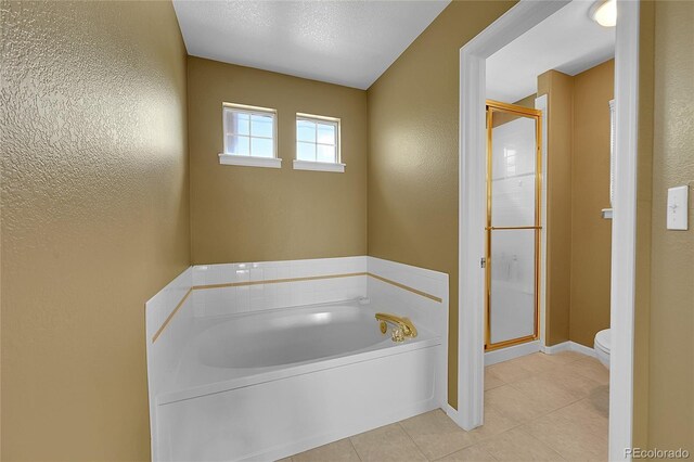 bathroom with tile patterned flooring, toilet, independent shower and bath, and a textured ceiling