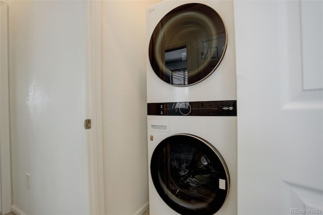 laundry area with laundry area and stacked washer / drying machine