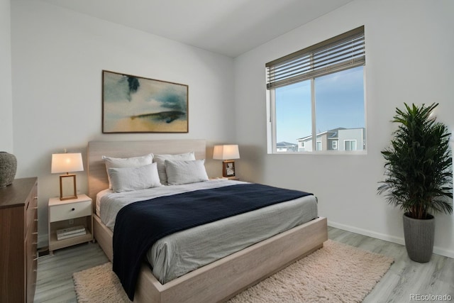 bedroom featuring light wood-style flooring and baseboards