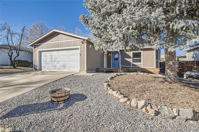 view of front of house with an attached garage, fence, and concrete driveway