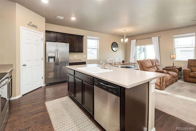 19468 E 65th Pl, Aurora, CO 80019 - kitchen with appliances with stainless steel finishes, a sink, open floor plan, light countertops, and plenty of natural light