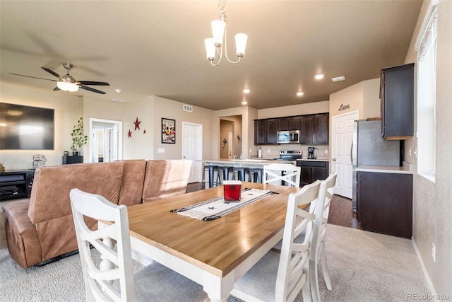 19468 E 65th Pl, Aurora, CO 80019 - dining area featuring light carpet, a chandelier, recessed lighting, a ceiling fan, and baseboards
