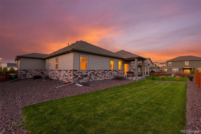 19468 E 65th Pl, Aurora, CO 80019 - rear view of house featuring a patio and stone siding