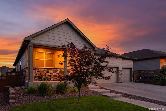 19468 E 65th Pl, Aurora, CO 80019 - view of front of house featuring stone siding, driveway, and an attached garage
