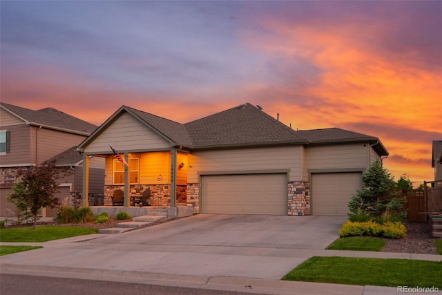 19468 E 65th Pl, Aurora, CO 80019 - view of front of home with an attached garage, a porch, driveway, and stone siding