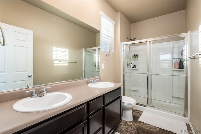 19468 E 65th Pl, Aurora, CO 80019 - full bathroom featuring a shower stall, double vanity, toilet, and healthy amount of natural light