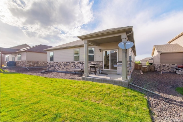 19468 E 65th Pl, Aurora, CO 80019 - rear view of property featuring a patio area, a yard, and stone siding