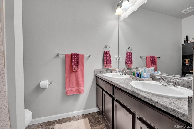 bathroom with vanity and toilet