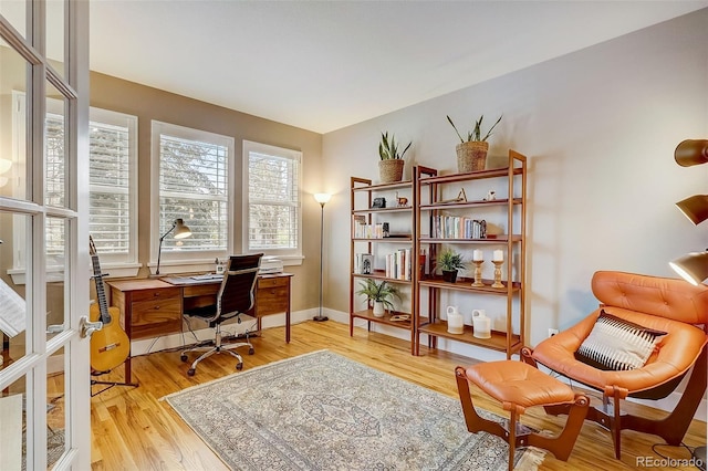 office space featuring light wood-style floors and baseboards