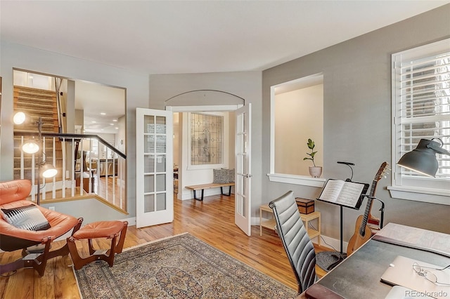 office space with baseboards, wood finished floors, and french doors