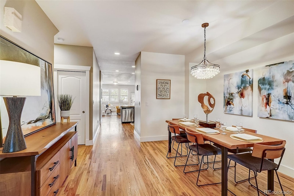 dining area with recessed lighting, baseboards, a notable chandelier, and light wood finished floors