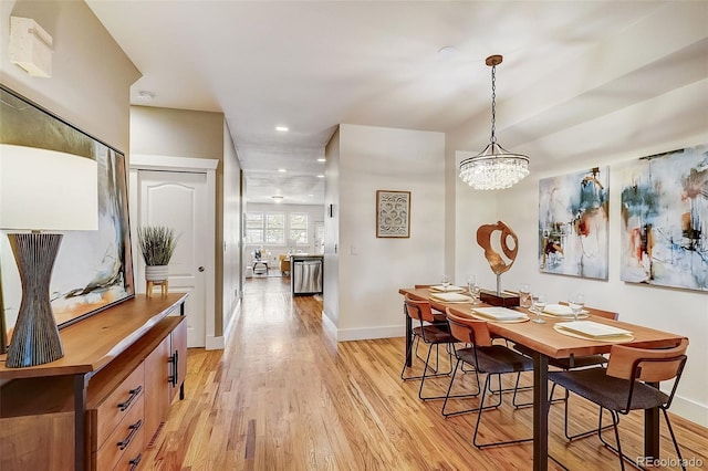 dining area with recessed lighting, baseboards, a notable chandelier, and light wood finished floors