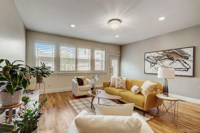 living area with light wood finished floors, baseboards, and recessed lighting