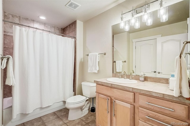 full bathroom featuring toilet, tile patterned floors, vanity, visible vents, and shower / tub combo with curtain