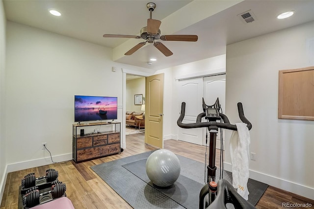 exercise room featuring ceiling fan, baseboards, wood finished floors, and recessed lighting