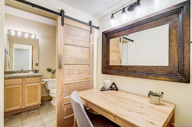 bathroom with vanity, toilet, and tile patterned floors