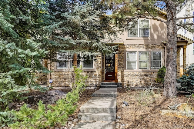 view of exterior entry featuring stone siding