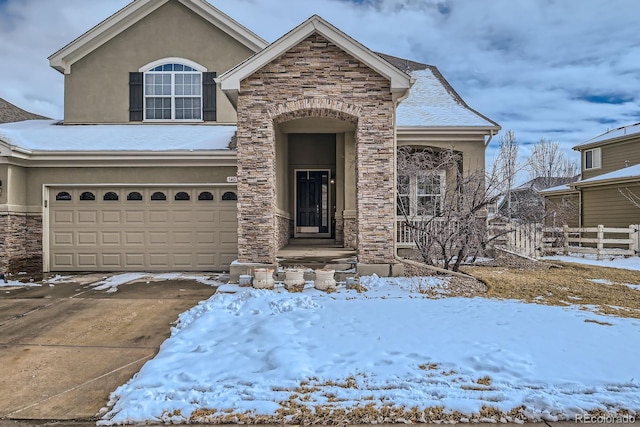 14096 Roaring Fork Cir, Broomfield, CO 80023 - view of front of house featuring stone siding, stucco siding, an attached garage, and driveway