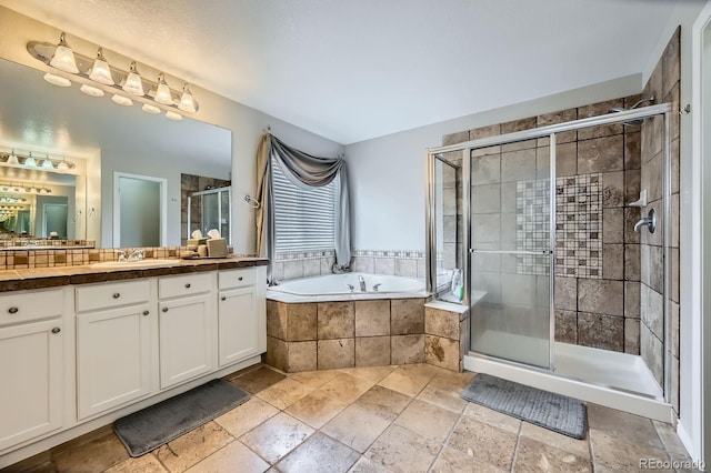 14096 Roaring Fork Cir, Broomfield, CO 80023 - full bath featuring vanity, a garden tub, a stall shower, and stone tile floors