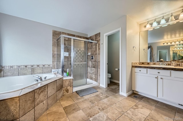 14096 Roaring Fork Cir, Broomfield, CO 80023 - bathroom with vanity, a bath, a shower stall, and stone tile floors