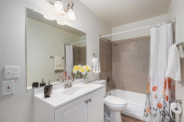 full bathroom featuring shower / bath combo, vanity, toilet, a textured wall, and wood finished floors