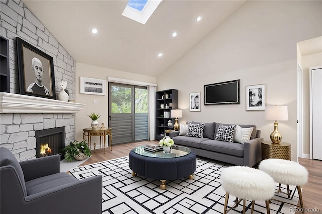 10150 E Virginia Ave Unit 7-304, Denver, CO 80247 - living area with high vaulted ceiling, wood finished floors, recessed lighting, a skylight, and a stone fireplace