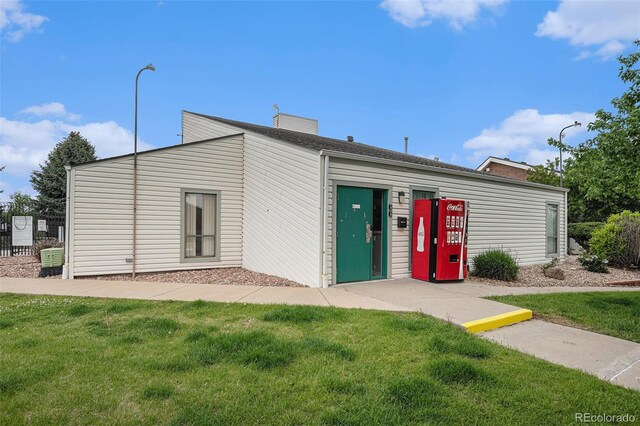 10150 E Virginia Ave Unit 7-304, Denver, CO 80247 - view of front facade featuring a front yard and a chimney