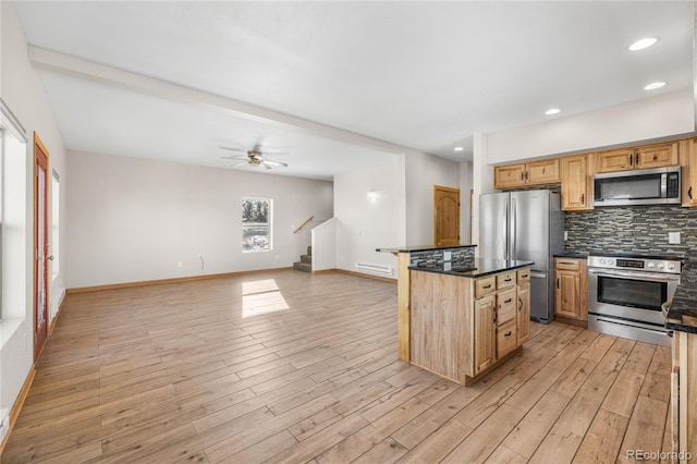 5844 Middle Fork Vis, Fairplay, CO 80440 - kitchen featuring appliances with stainless steel finishes, decorative backsplash, light wood-type flooring, open floor plan, and recessed lighting