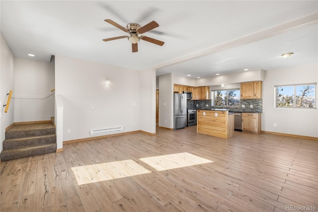 5844 Middle Fork Vis, Fairplay, CO 80440 - kitchen featuring a baseboard heating unit, stainless steel appliances, a ceiling fan, tasteful backsplash, and light wood-style floors
