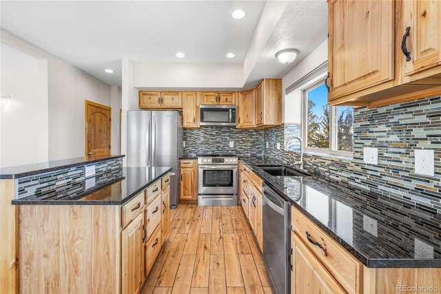 5844 Middle Fork Vis, Fairplay, CO 80440 - kitchen with stainless steel appliances, light wood-style floors, dark stone countertops, tasteful backsplash, and recessed lighting
