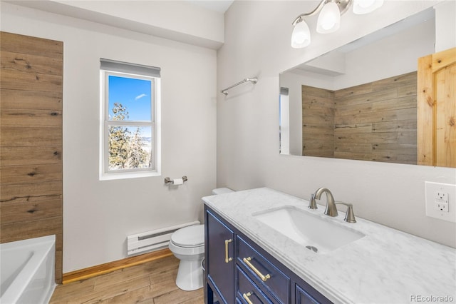 5844 Middle Fork Vis, Fairplay, CO 80440 - bathroom with baseboard heating, vanity, wood finished floors, and a bathtub