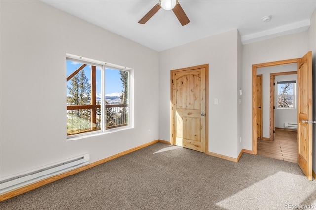 5844 Middle Fork Vis, Fairplay, CO 80440 - unfurnished bedroom featuring a baseboard radiator, carpet flooring, multiple windows, and a baseboard heating unit