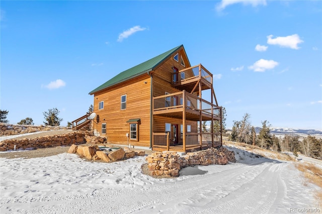 5844 Middle Fork Vis, Fairplay, CO 80440 - snow covered property with a balcony, a metal roof, and a deck