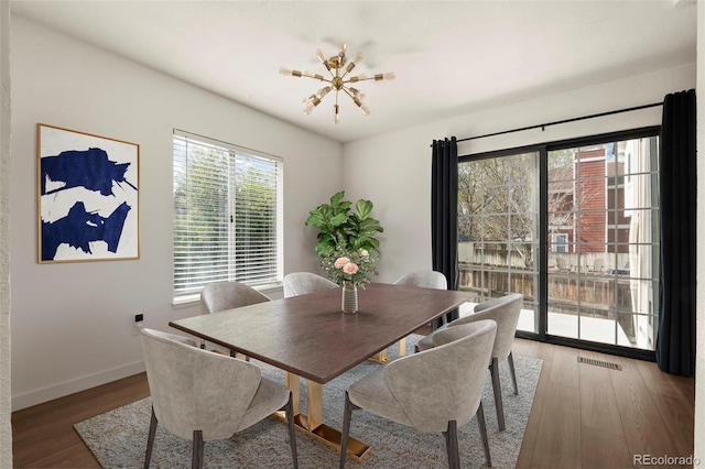 dining space with wood finished floors and baseboards