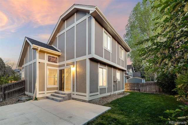 back of house with a patio area, stucco siding, and a sunroom