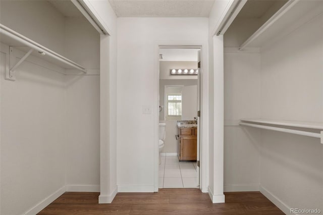 spacious closet featuring wood finished floors