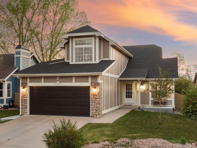 view of front facade with stone siding, board and batten siding, concrete driveway, and roof with shingles