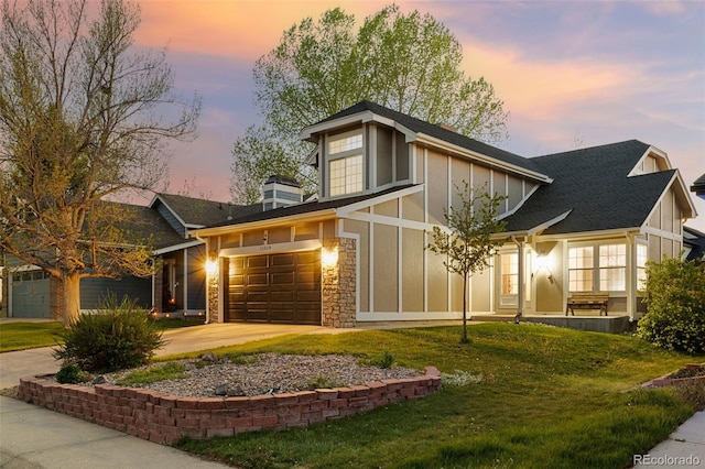 back of house featuring board and batten siding, driveway, and a yard