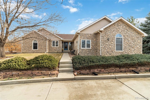 ranch-style house with stone siding